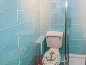 a bathroom with a toilet with an anchor on it at Whitby Sands in Whitby