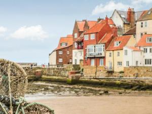 a group of houses in a town on the beach at Whitby Sands in Whitby