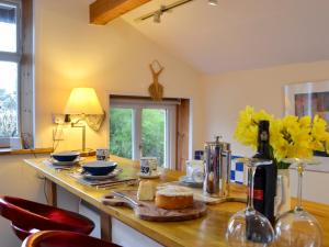 a kitchen with a counter with a table with food on it at Gardeners Cottage in Near Sawrey