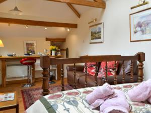 a bedroom with a bed and a couch at Gardeners Cottage in Near Sawrey