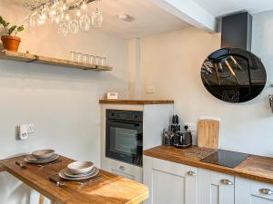 a kitchen with a counter top and a stove at The Snug in Southwell