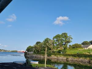 a view of a river with two boats in it at West End Waterfront in Castletownbere +3 photos