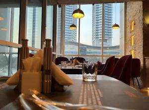 a table in a restaurant with a view of a city at Skyline Premium Luxury Apartments Elysium Facing Centaurus Mall Islamabad - LMY in Islamabad