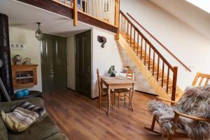 a living room with a table and a staircase at In de Dikke Bertha in Wapse