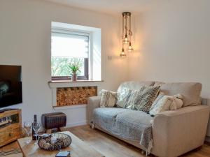 a living room with a couch and a window at Black Spout Cottage in Moulin