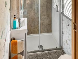 a bathroom with a shower and a toilet and a sink at Goldfinch - Uk48551 in Colchester +8 photos