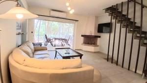 a living room with a couch and a table at Villa Irida in Nea Makri
