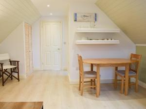 a dining room with a wooden table and chairs at Bakers Retreat in Freshwater