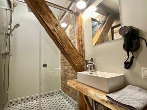a bathroom with a sink and a shower at Svētes klubs 