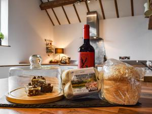 a bottle of wine and a container of food and bread at The Barn in Nantwich +13 photos