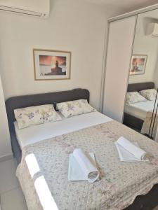a bedroom with a bed with two towels on it at City center Apartman Gabriel in Podgora