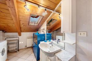 a bathroom with a sink and a washing machine at La Liguria tra gli Ulivi 2 in Varazze