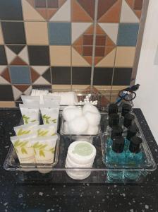 a tray with toiletries and other items on a counter at Olde Farm Holiday Cottages in Banham