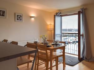 a dining room with a table and a balcony at Sovereign House in Milford Haven