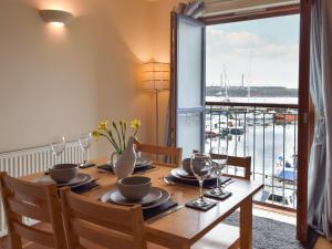 a dining room with a table with a view of a marina at Sovereign House in Milford Haven