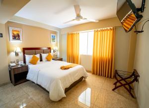 a bedroom with a large bed and a window at Gran Recreo Hotel - Trujillo - Perú in Trujillo