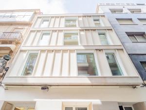 a white building with many windows at YBH Atlantic Boutique in Vigo