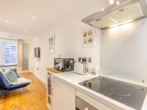 a kitchen with a sink and a microwave at Town Square Apartment - Uk45611 in Alnwick