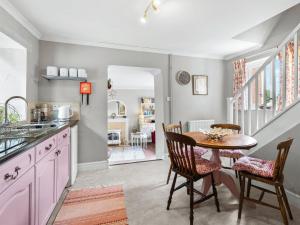 a kitchen with a table and chairs and a dining room at The Coach House- Uk45660 in Bishops Castle