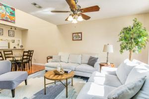 a living room with a couch and a ceiling fan at Sunny Large Two Bedroom Townhouse - Pool in Pensacola