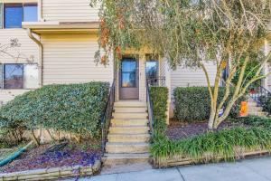 a house with stairs leading up to a door at Sunny Large Two Bedroom Townhouse - Pool in Pensacola