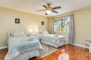 a bedroom with two beds and a ceiling fan at Sunny Large Two Bedroom Townhouse - Pool in Pensacola +24 photos