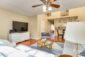 a living room with a couch and a flat screen tv at Sunny Large Two Bedroom Townhouse - Pool in Pensacola