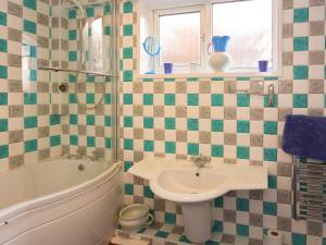 a bathroom with a sink and a tub and a toilet at Blue - Uk43119 in Trefor +8 photos