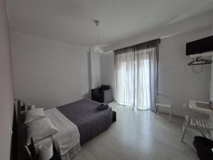 a bedroom with a bed and a large window at Il Guasco Rooms in Ancona