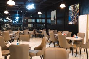 a dining room filled with tables and chairs at Hotel Blue Corner 2 in Erbil