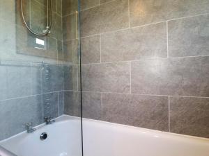 a bathroom with a shower and a bath tub at The Studio in Truro +23 photos
