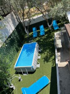 an overhead view of a swimming pool and blue chairs at Mone luxury villa in Vlorë