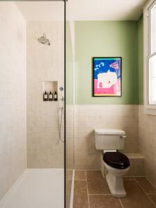 a bathroom with a shower and a toilet and a sink at The Pembroke Arms in Salisbury +47 photos