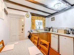 a kitchen with a table and chairs in a room at Withnail's Hideaway - Uk43429 in Whitby