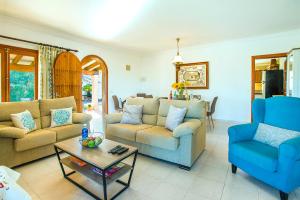 a living room with two couches and a coffee table at Villa GERANIOS in El Port