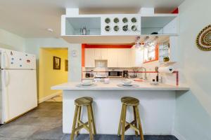 a kitchen with two bar stools and a counter top at 5 Mi to Surfside Beach Peaceful Miami Bungalow! in Miami