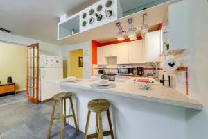 a kitchen with a large counter and two stools at 5 Mi to Surfside Beach Peaceful Miami Bungalow! in Miami +17 photos