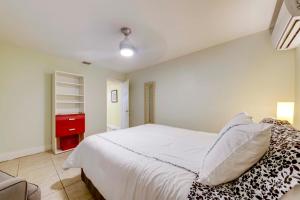 a bedroom with a white bed and a red cabinet at 5 Mi to Surfside Beach Peaceful Miami Bungalow! in Miami