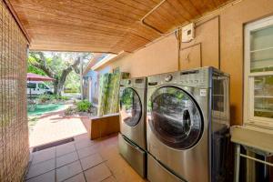 a washer and dryer in a room with a window at 5 Mi to Surfside Beach Peaceful Miami Bungalow! in Miami