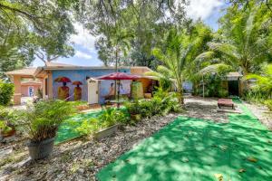 a house with a swimming pool and a yard at 5 Mi to Surfside Beach Peaceful Miami Bungalow! in Miami