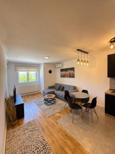 a living room with a couch and a table at Kovan Lux 9 Sokobanja in Soko Banja