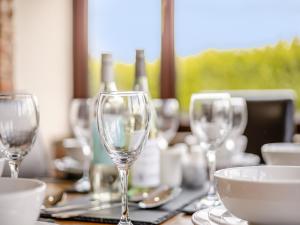 a table with wine glasses on top of it at Casa Mia in Terrington Saint John
