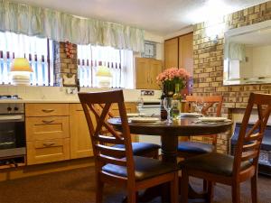 a kitchen with a table and chairs in a kitchen at Idagale in Whitby