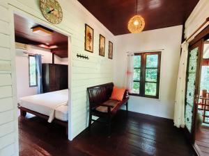a bedroom with a bed and a chair at Baan Moonchan House in Chaloklum +72 photos