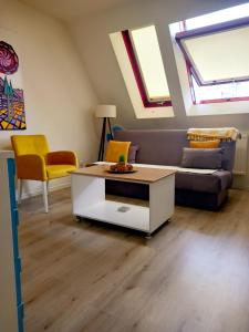 a living room with a couch and a table at Ena Apartment in Tuzla