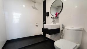 a bathroom with a white toilet and a mirror at MagTree Chinatown in Kuala Lumpur