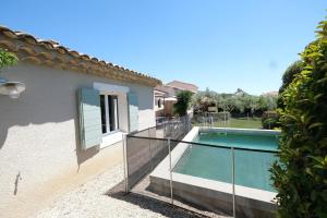 a villa with a swimming pool and a house at nice villa with heated swimming pool, in the center of the village of aureille, 8 persons, near baux de provence, in the alpilles in Aureille