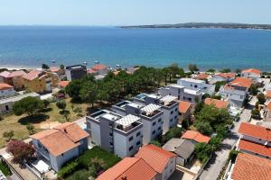 an aerial view of a town next to the ocean at K2-Penthouse with sea view and heated pool in Vir