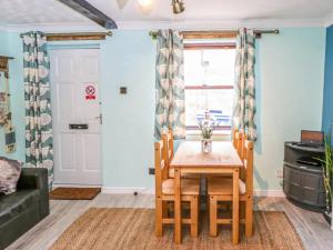 a dining room with a table and chairs at Whitby Sands in Whitby