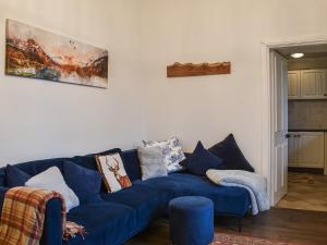 a blue couch sitting in a living room at Beeches in Windermere